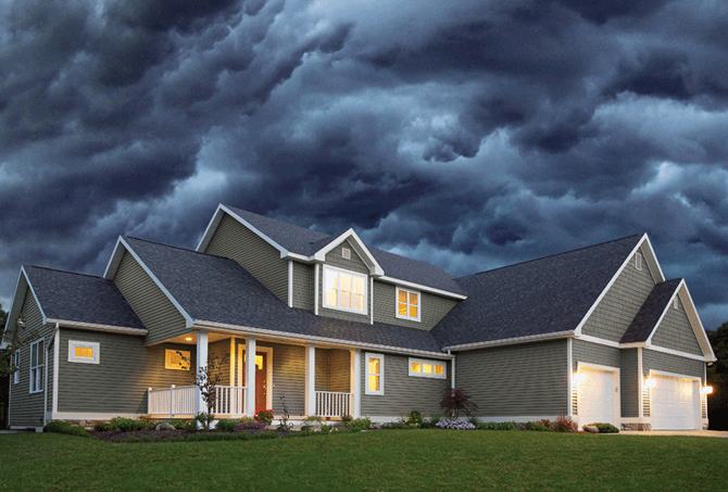 Inspector marking hail damage on asphalt shingles