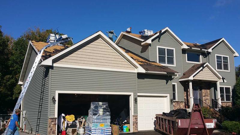 ARCM Roofing inspector documenting storm damage for an insurance claim