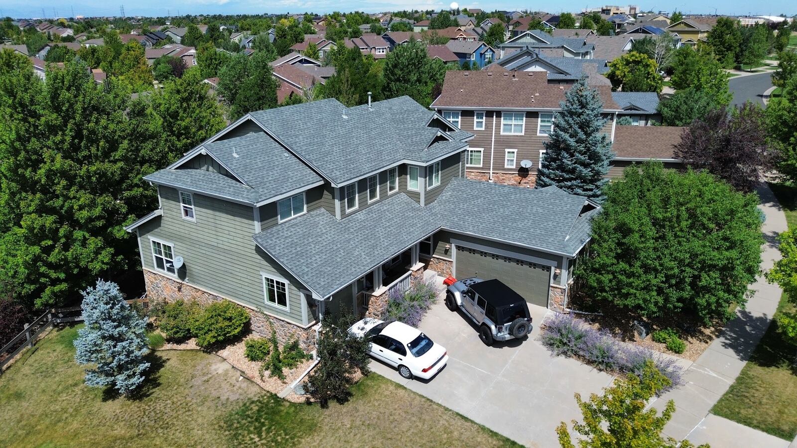 Two-story home in Aurora, Colorado with a completed asphalt shingle roof replacement by ARCM Roofing