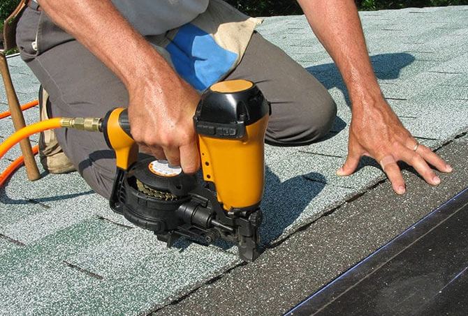 ARCM Roofing technician repairing asphalt shingles