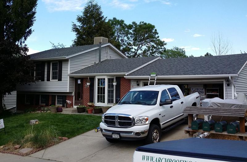 ARCM Roofing crew installing shingles on a residential roof